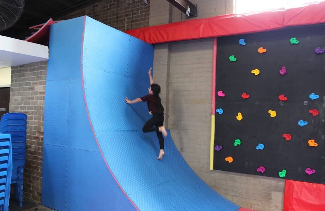 Student climbing the warped wall during a school excursion